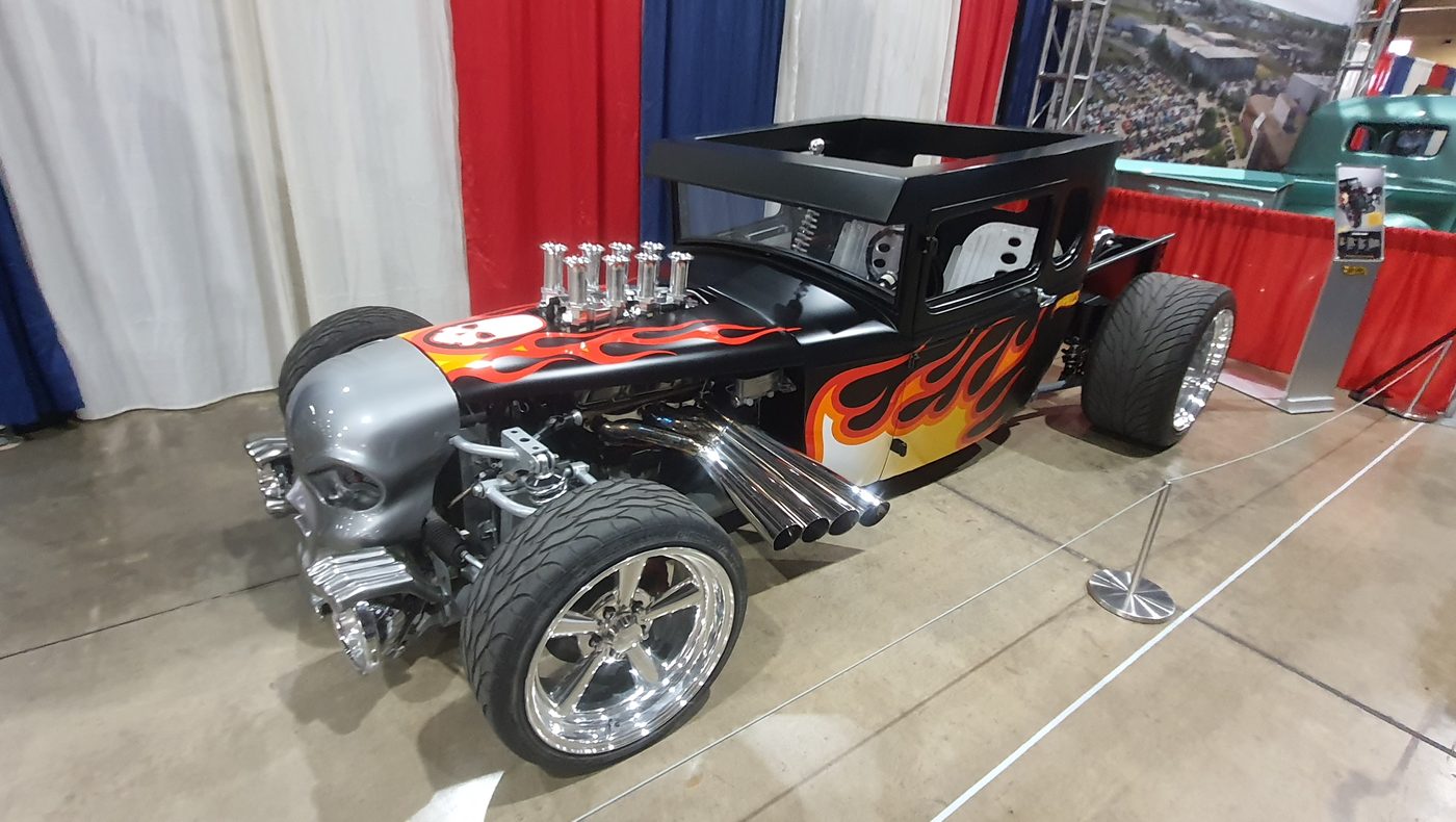 Czarny pickup hot rod bez dachu w pomarańczowych płomieniach