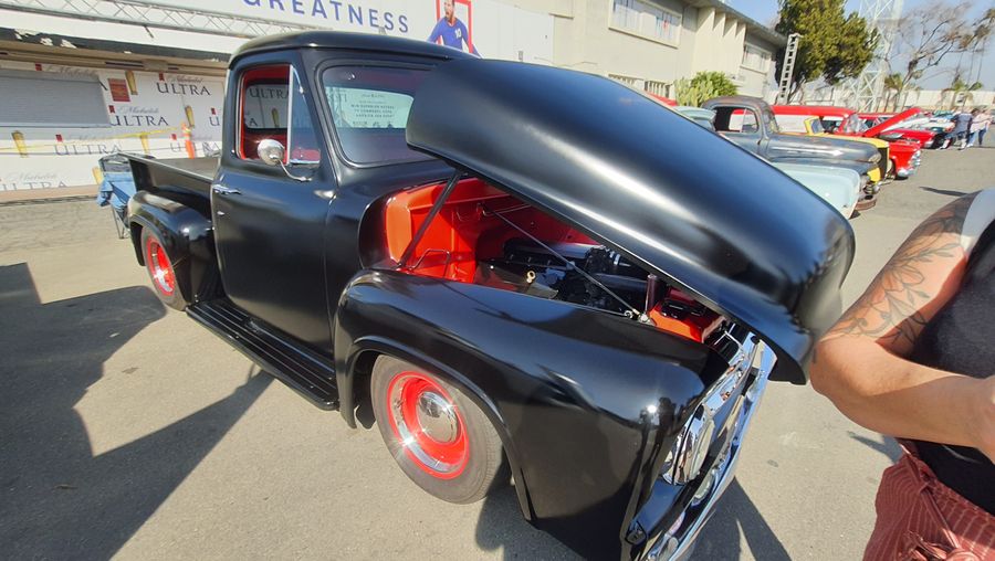 Czarny Ford F-100 z lat 50. z odchylaną maską i kompresorem